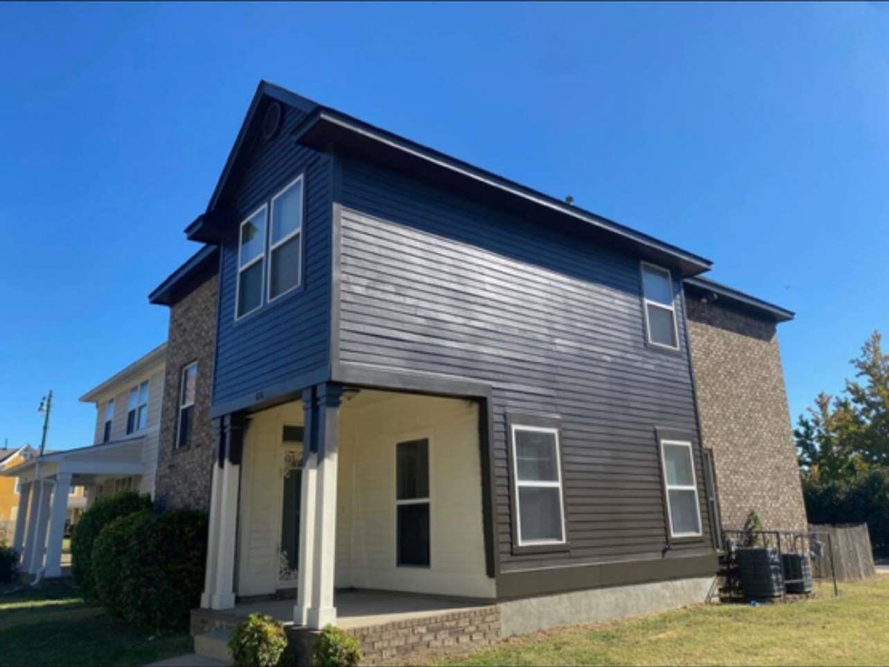 View of side of property featuring a lawn, central air condition unit, and a patio area