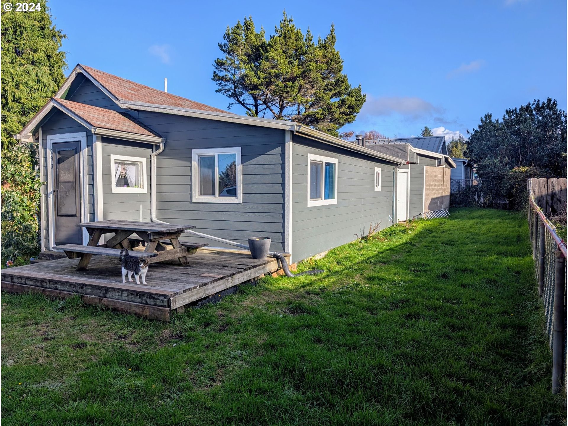 a view of a house with a yard and sitting area