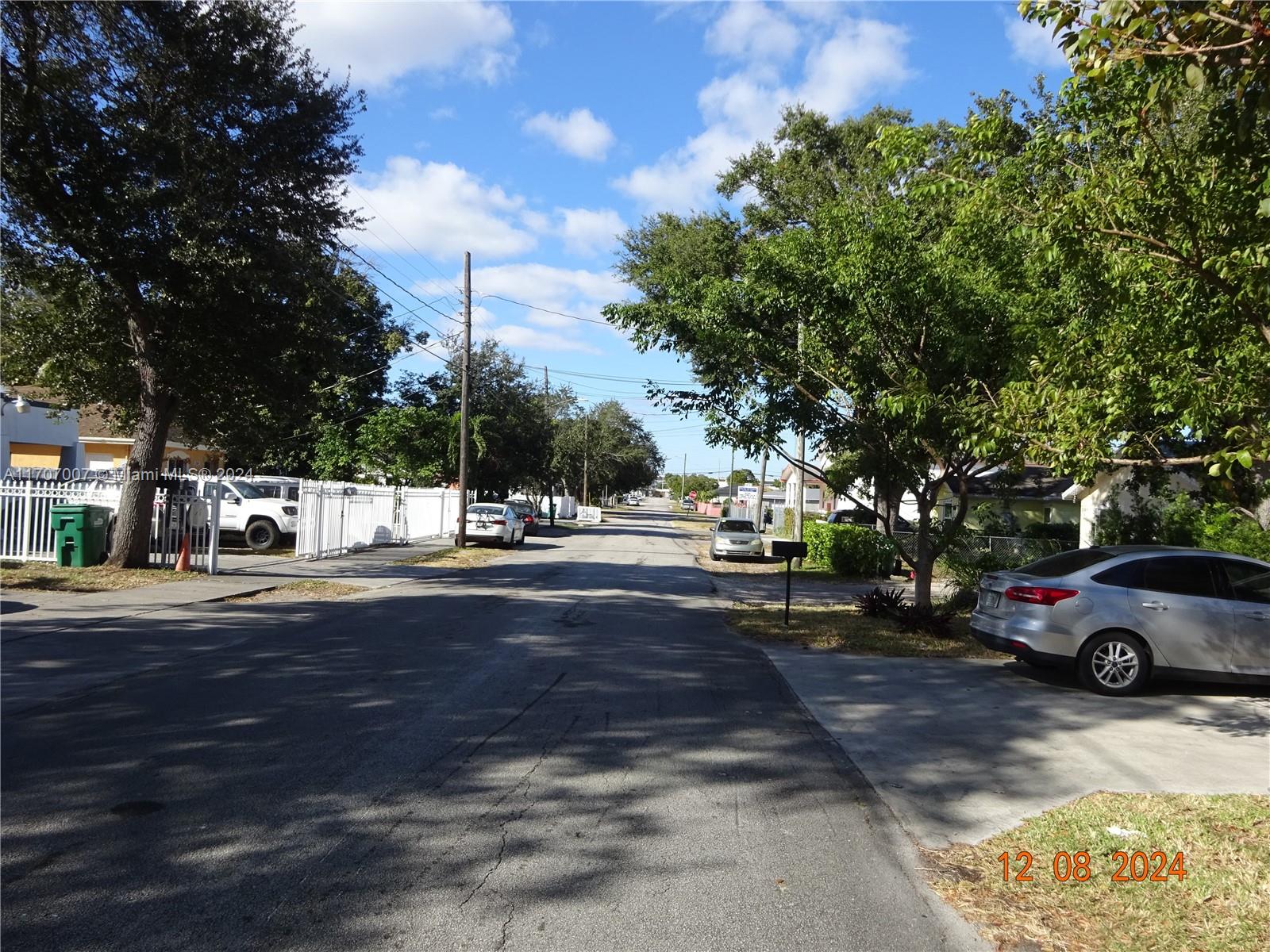 a view of street with parked cars