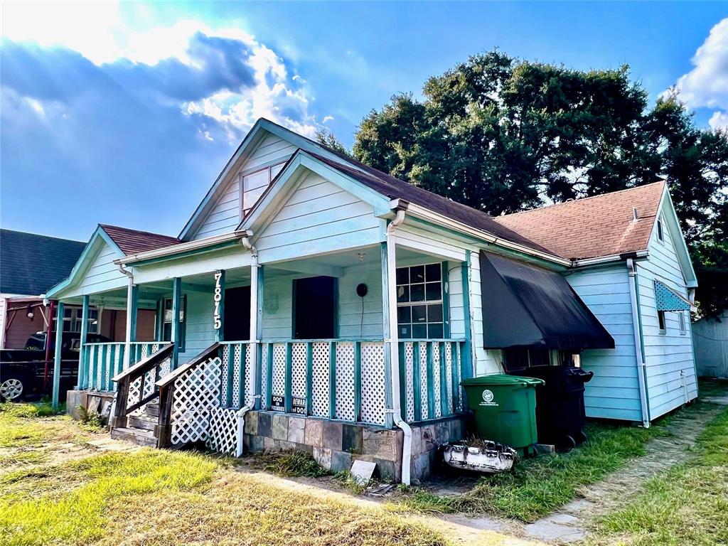 a view of a house with a yard and wooden fence