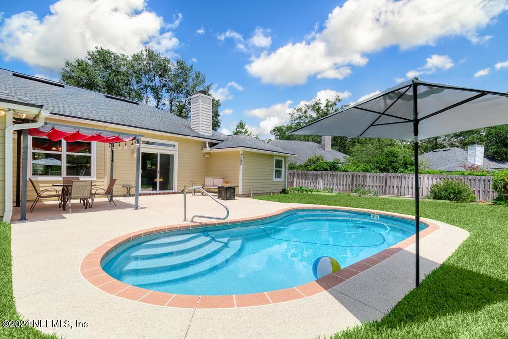 a view of a swimming pool with a patio