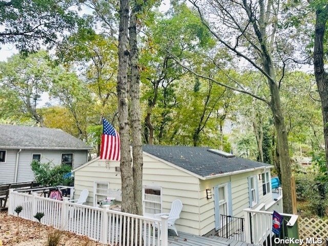 a view of house with a yard and seating area