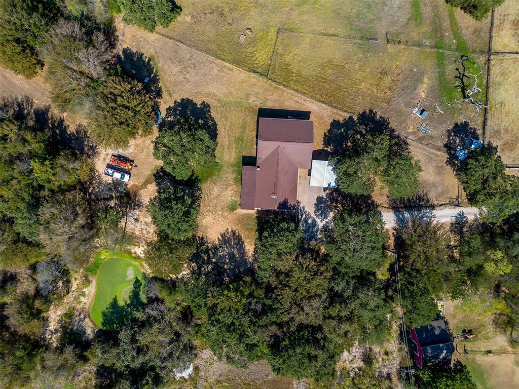 an aerial view of a house with a yard