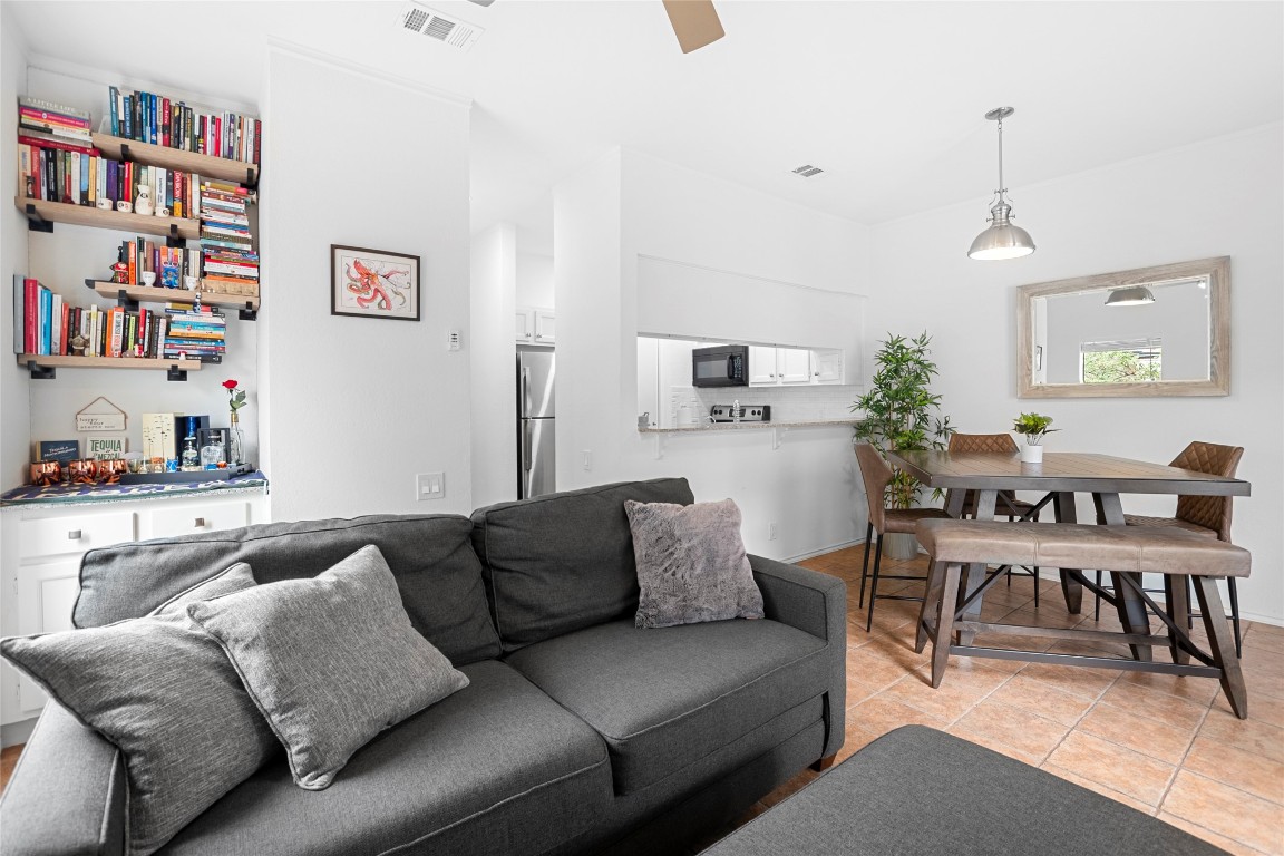 a living room with furniture and a book shelf