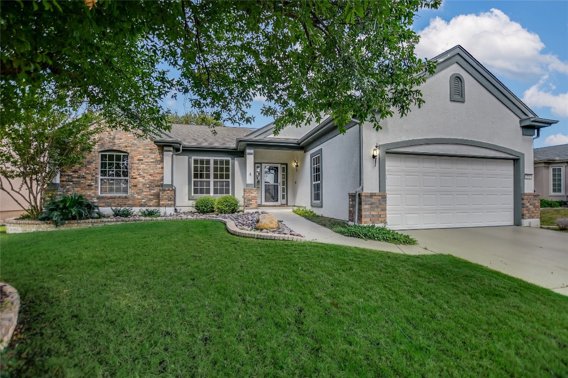 a front view of house with yard and green space