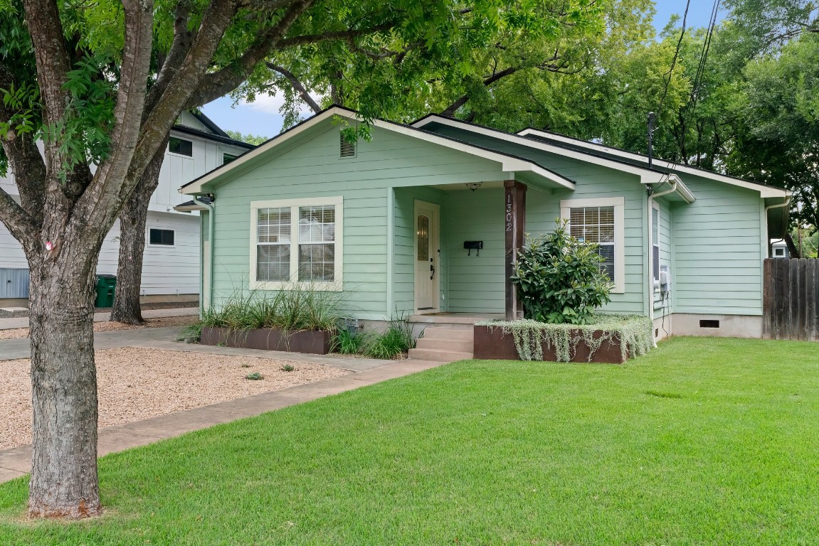 a front view of house with yard and green space