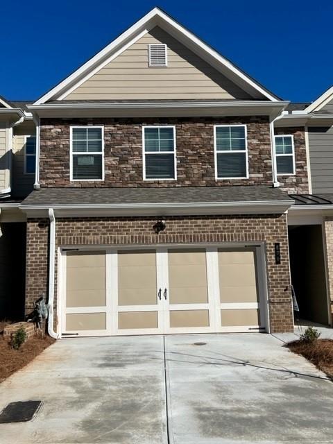 a front view of a house with a garage