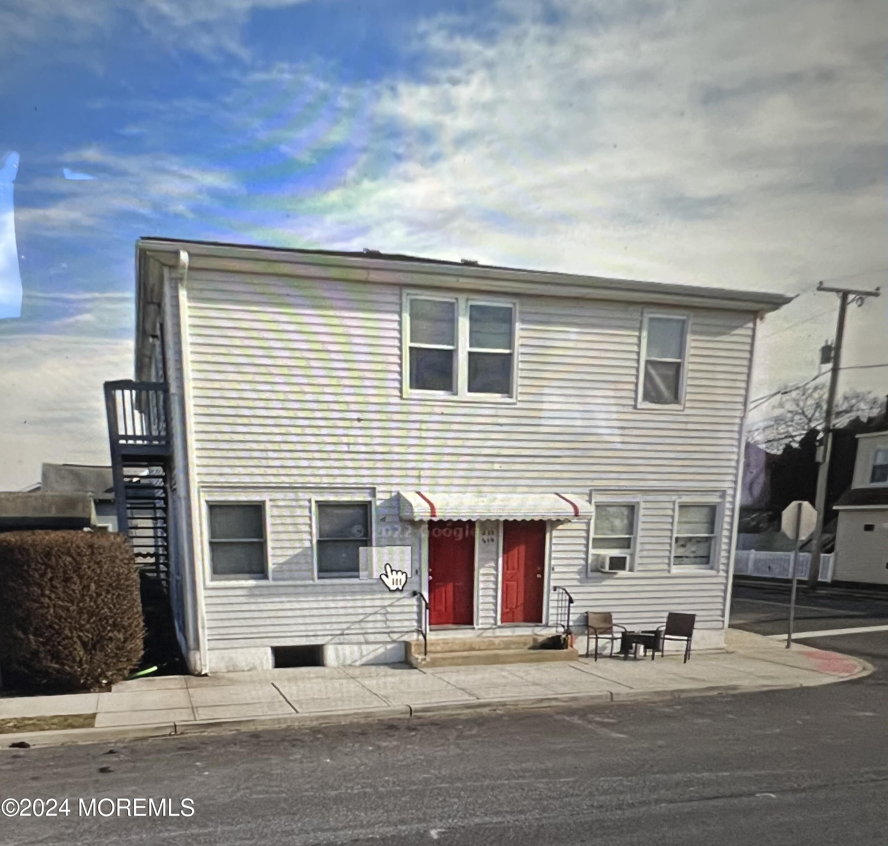 a front view of a house with a road