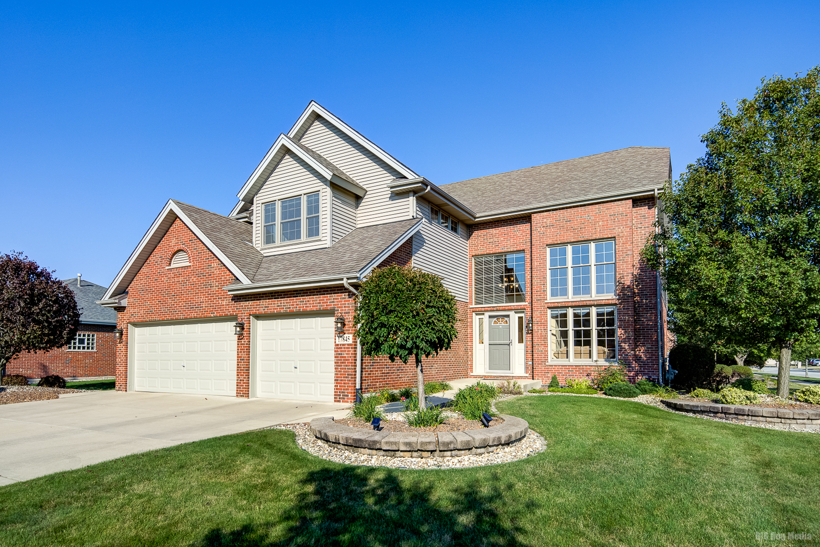 a front view of a house with a yard and garage