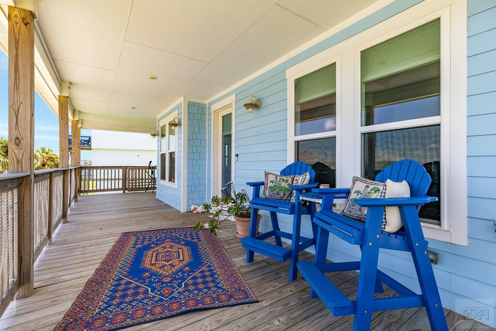 a outdoor dining area with furniture and wooden floor