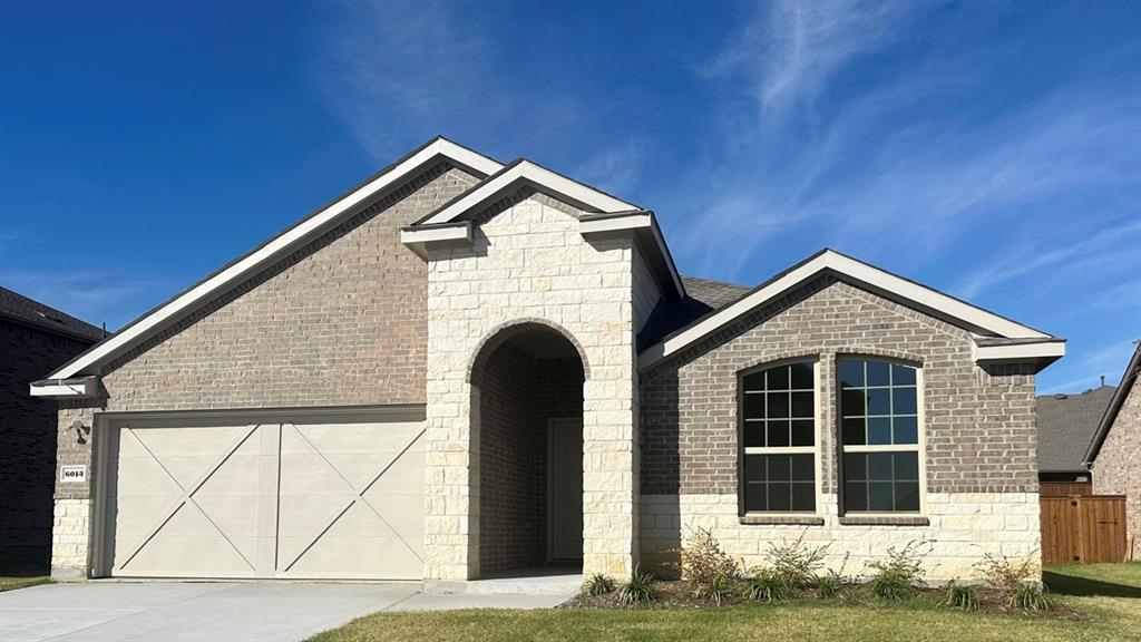 a front view of a house with garage