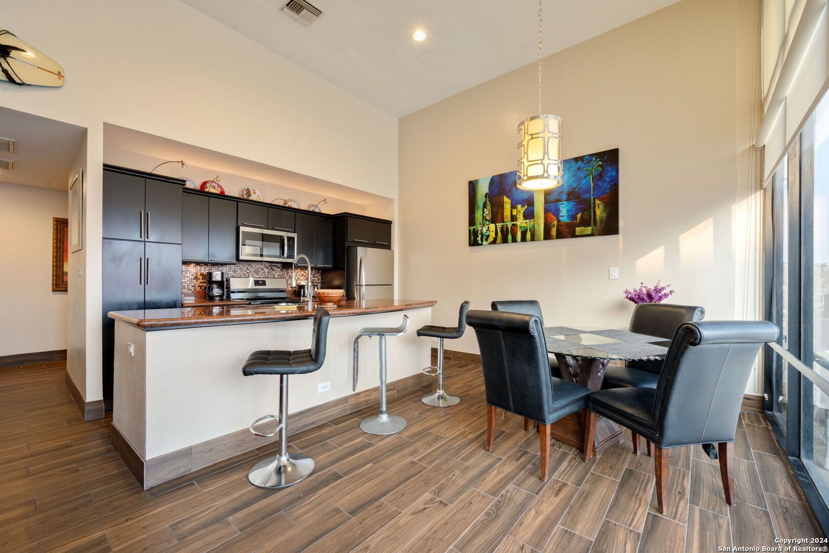 a kitchen with granite countertop white cabinets and stainless steel appliances