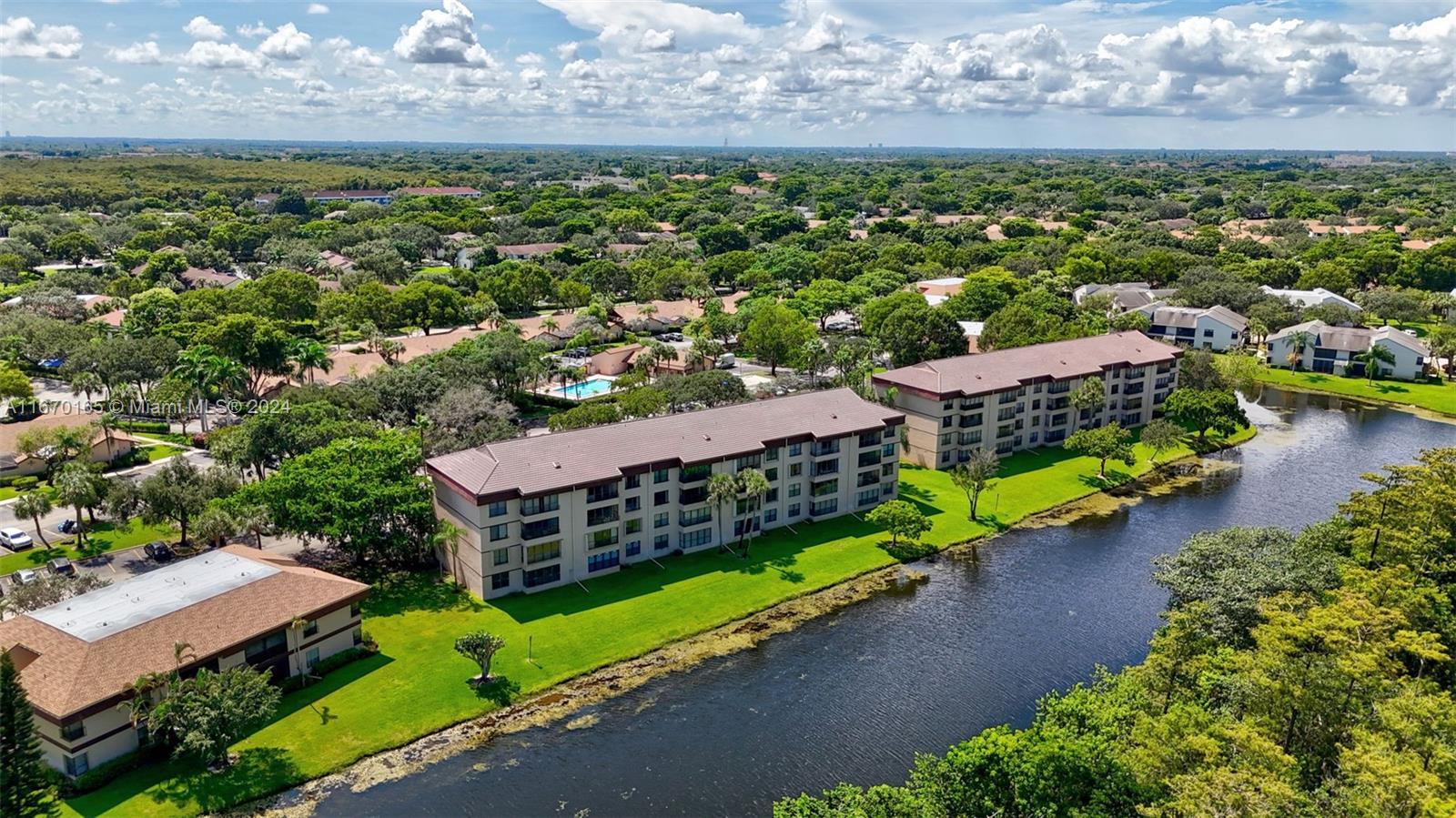 an aerial view of a house with a garden and lake view