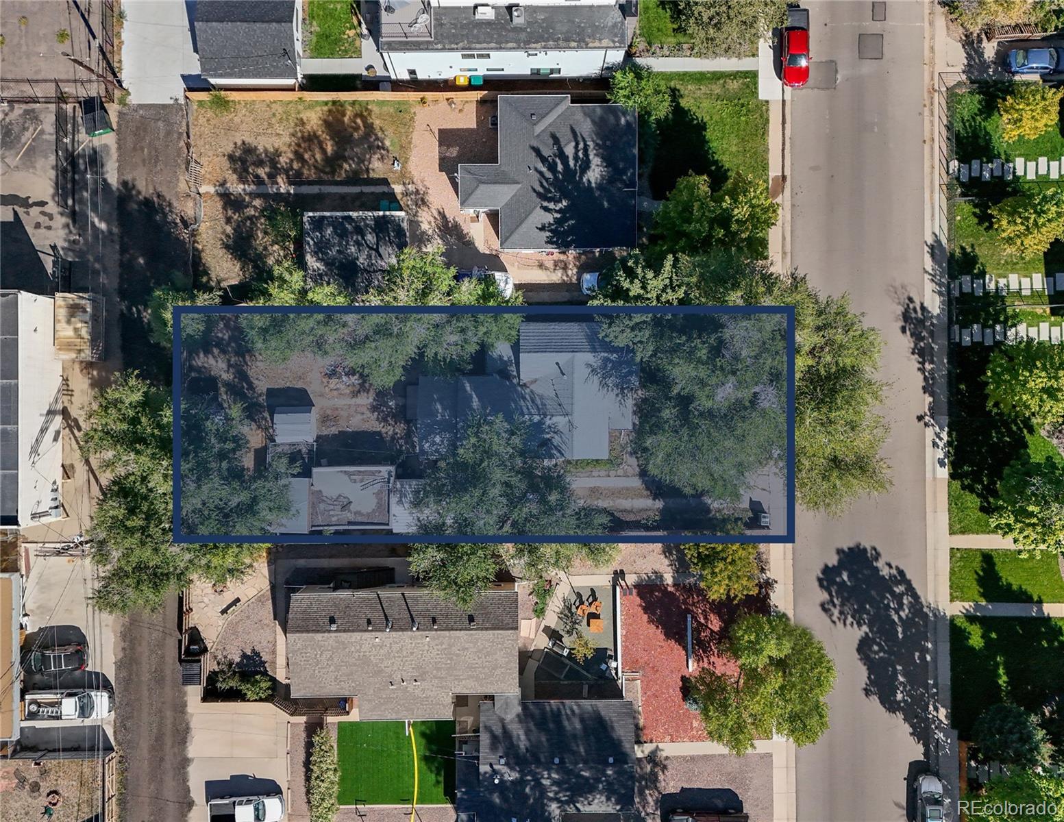 an aerial view of a houses with street