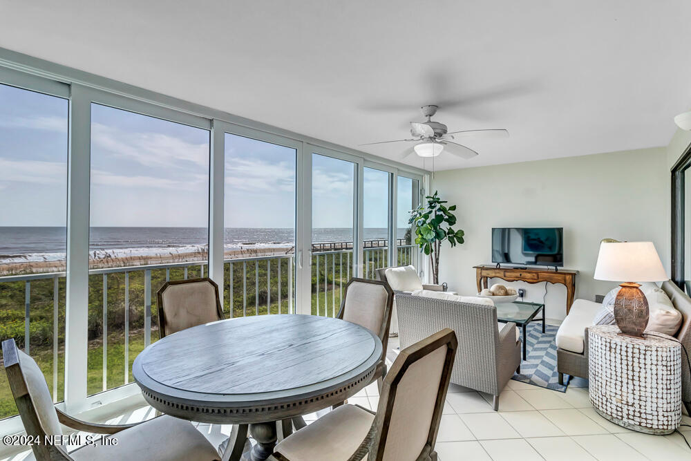 a living room with furniture a flat screen tv and a large window