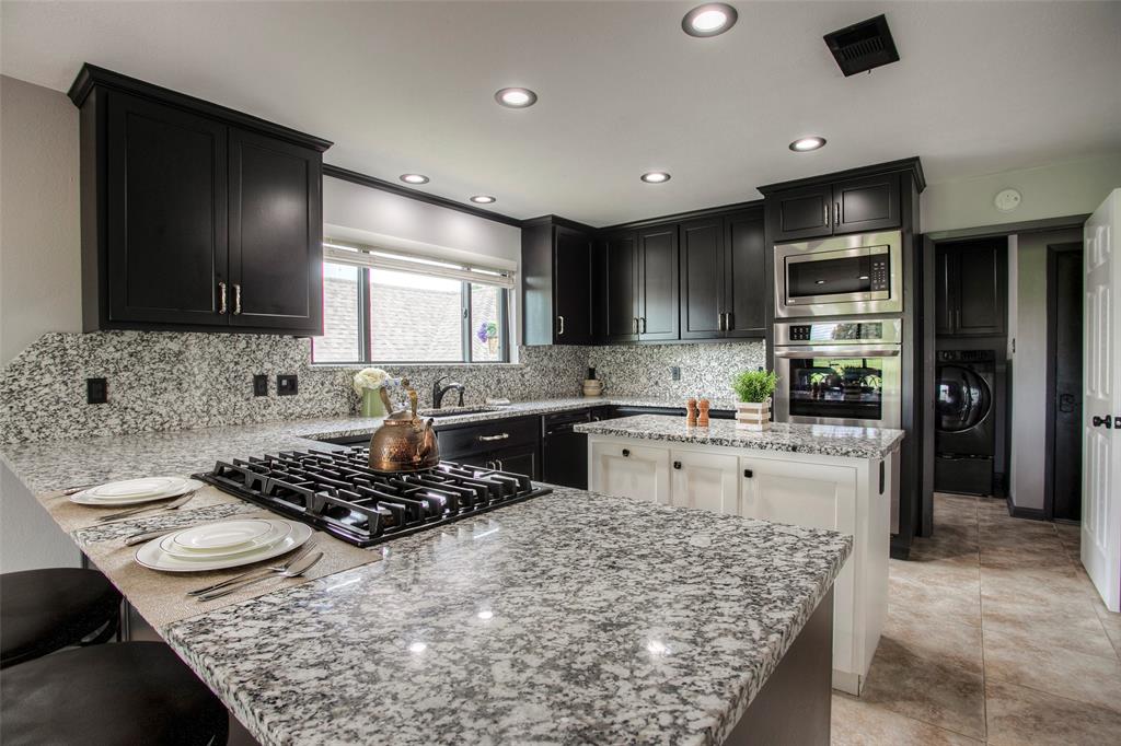 a kitchen with a stove a sink and a refrigerator