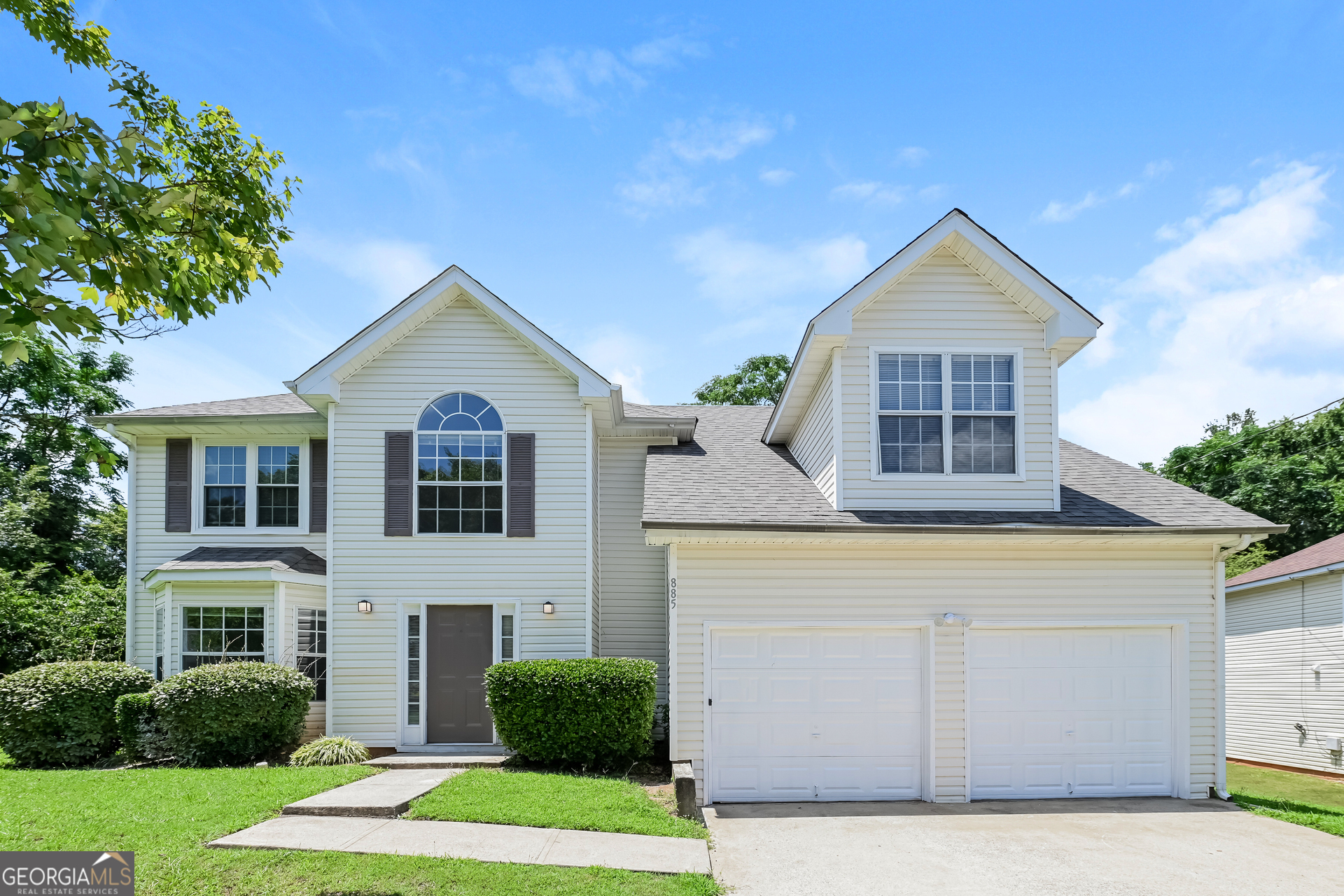 a front view of a house with a yard