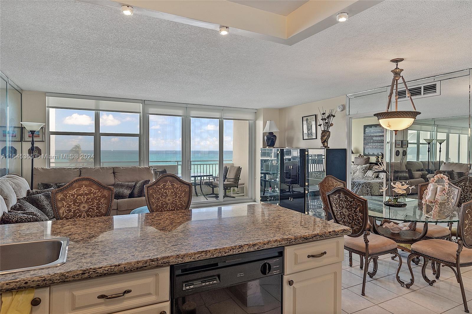 a kitchen with granite countertop a table and chairs