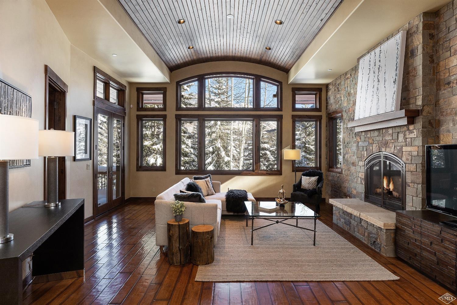 a living room with fireplace furniture and a large window