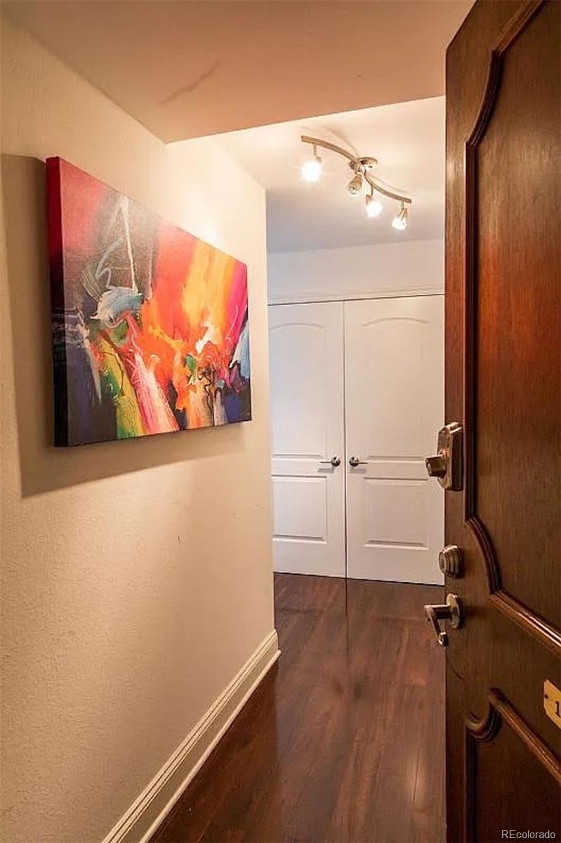 a view of a room with wooden floor