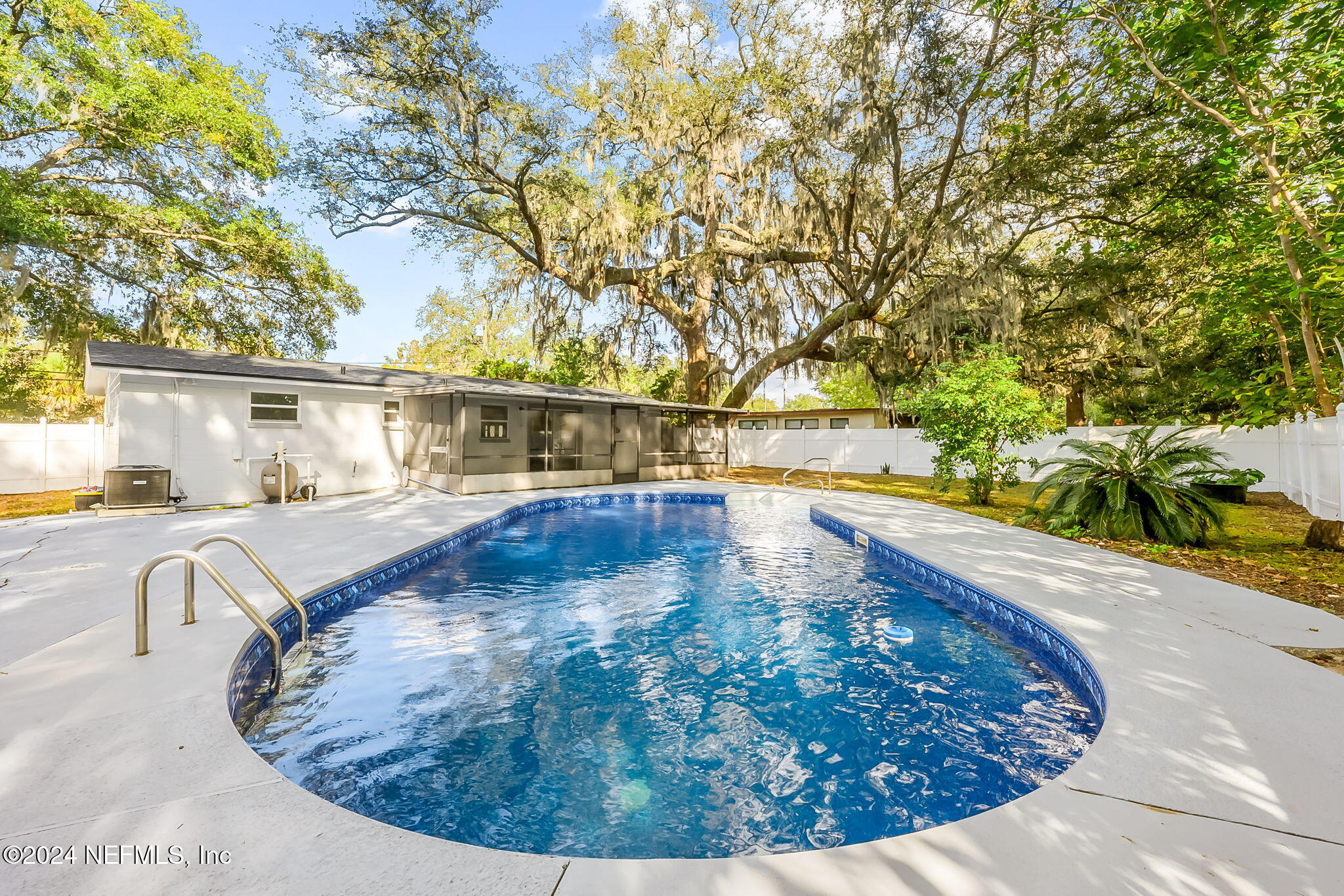 a view of a swimming pool with an outdoor seating