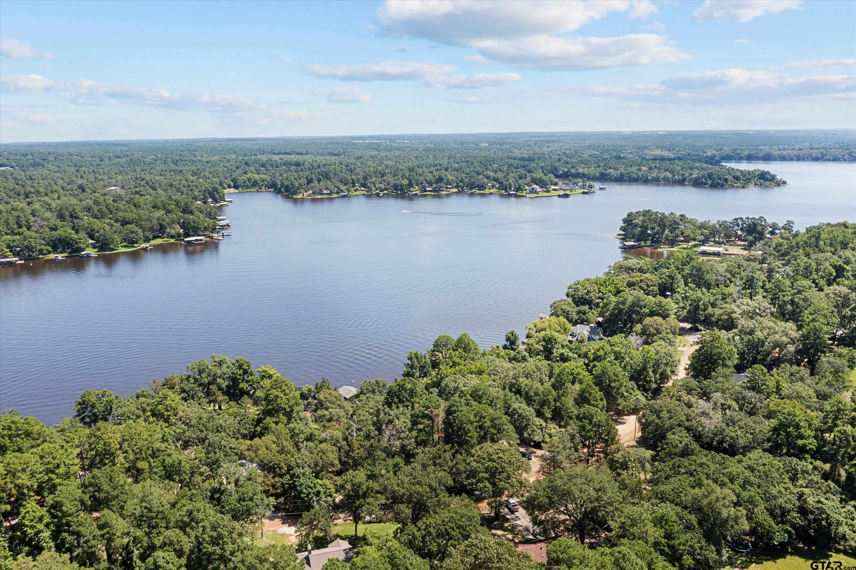 an aerial view of a houses with a lake view