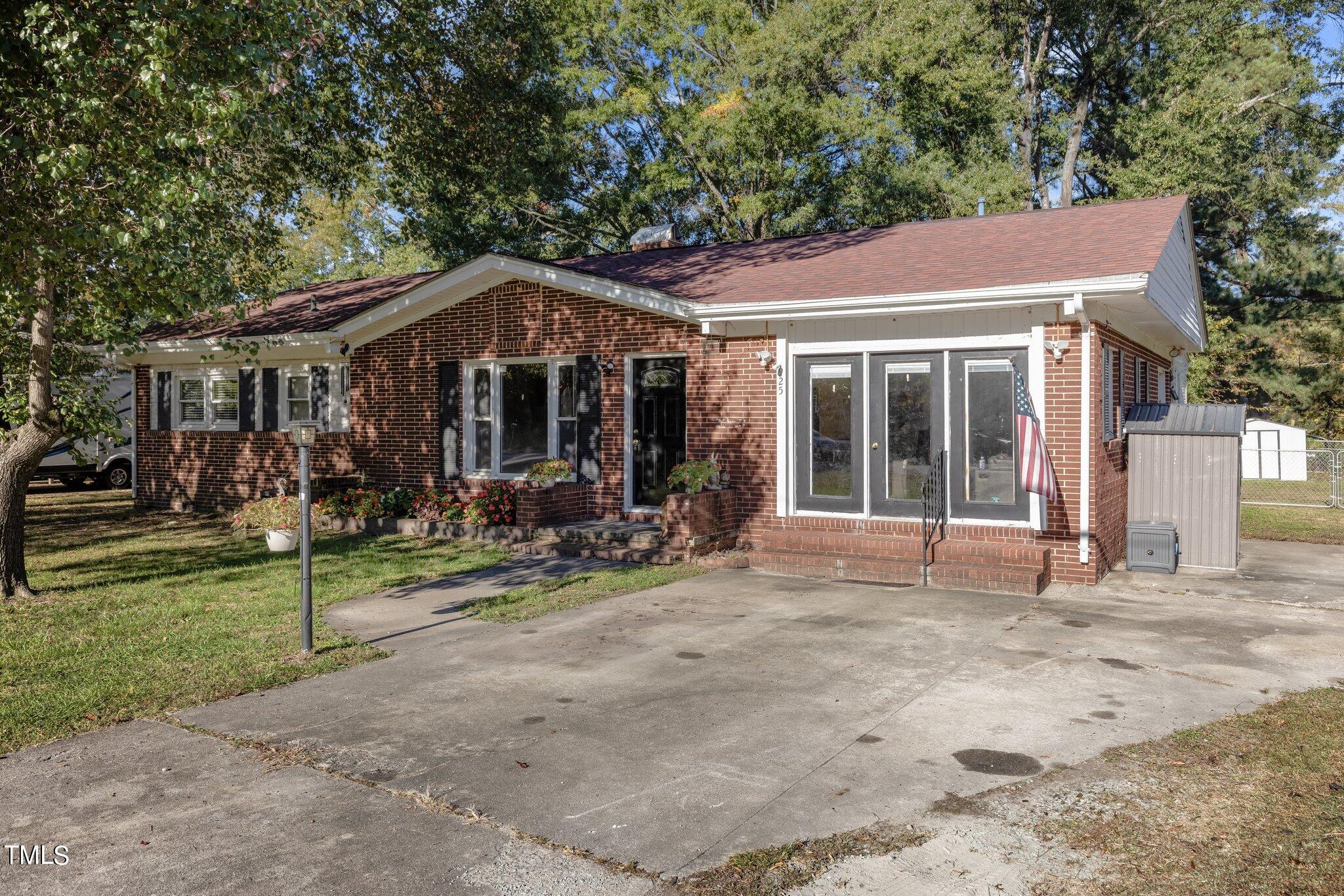 a view of a house with backyard porch and sitting area