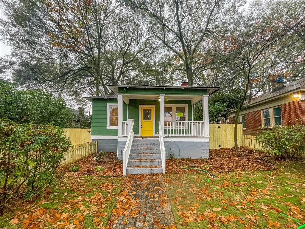 a view of house with backyard and garden