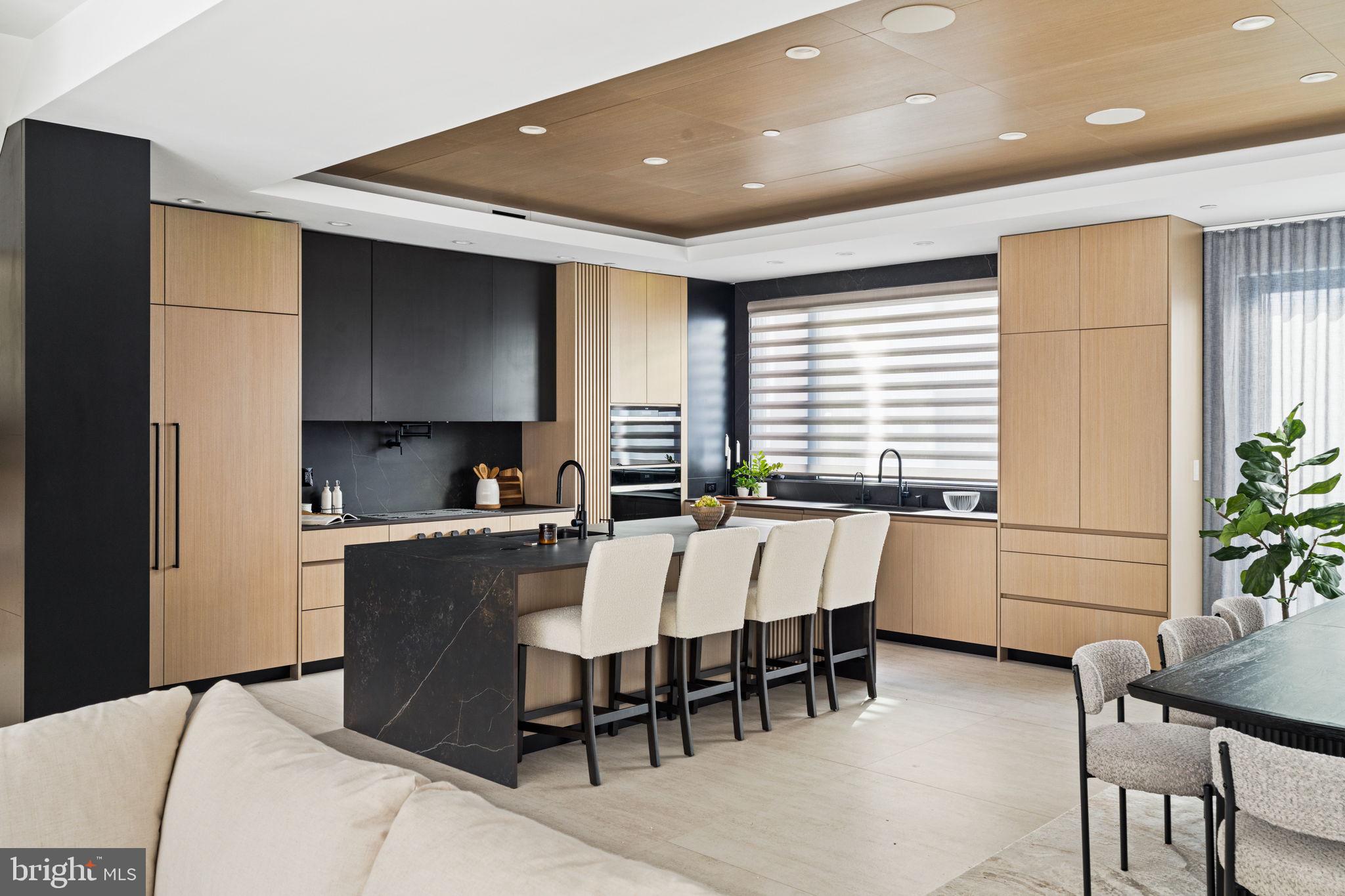 a large kitchen with a table and chairs in it