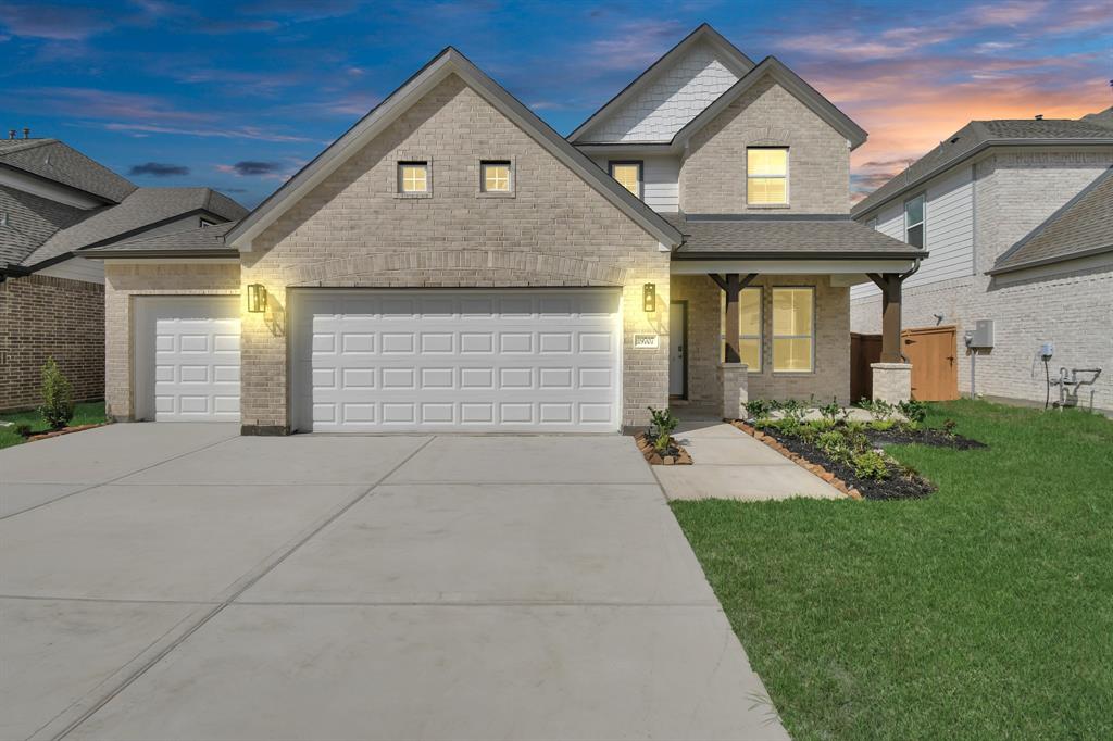 a front view of a house with a yard and garage