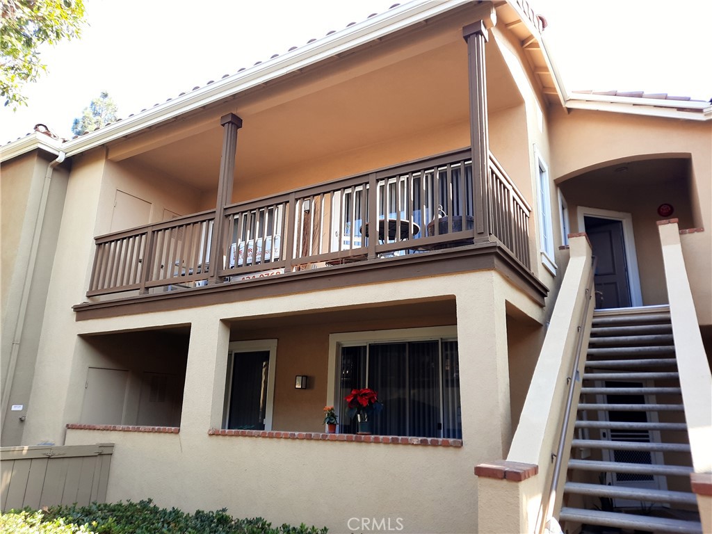 VIEW OF UPSTAIRS BALCONY AND STAIRS LEADING TO UNIT