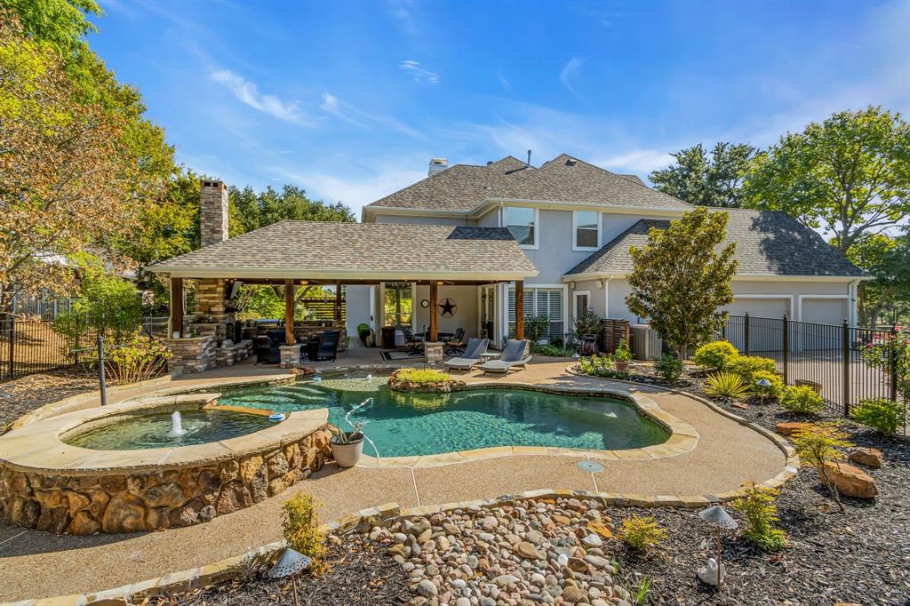 a front view of a house with swimming pool having outdoor seating