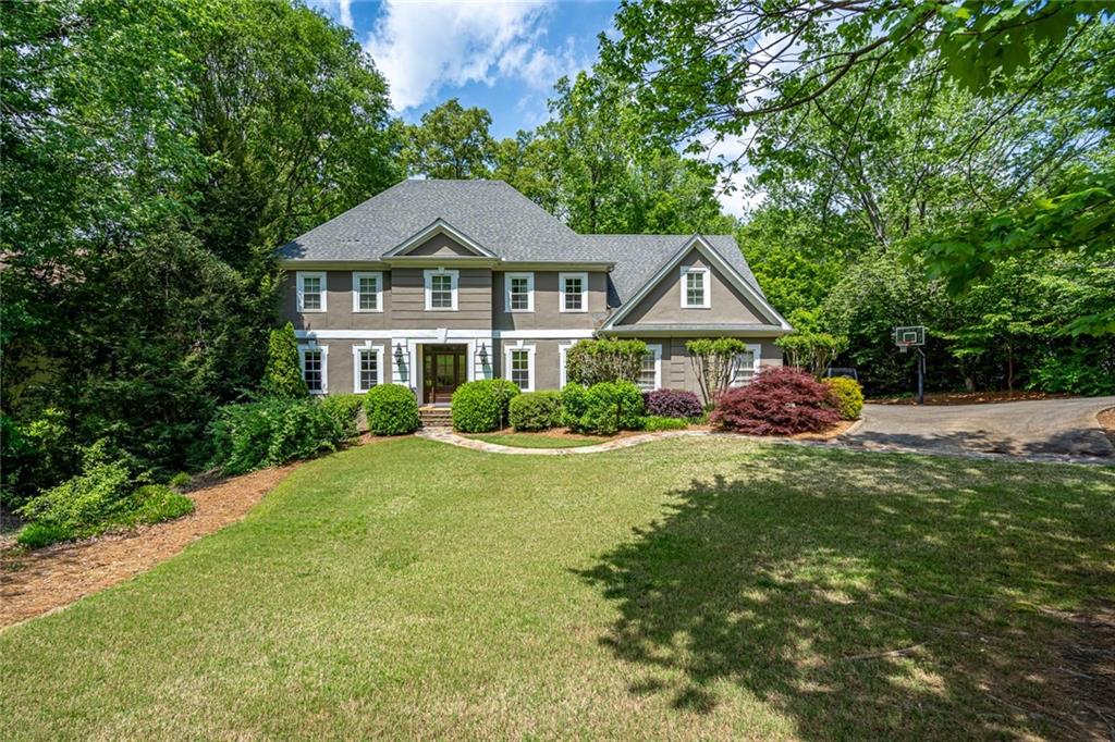 a front view of a house with a garden