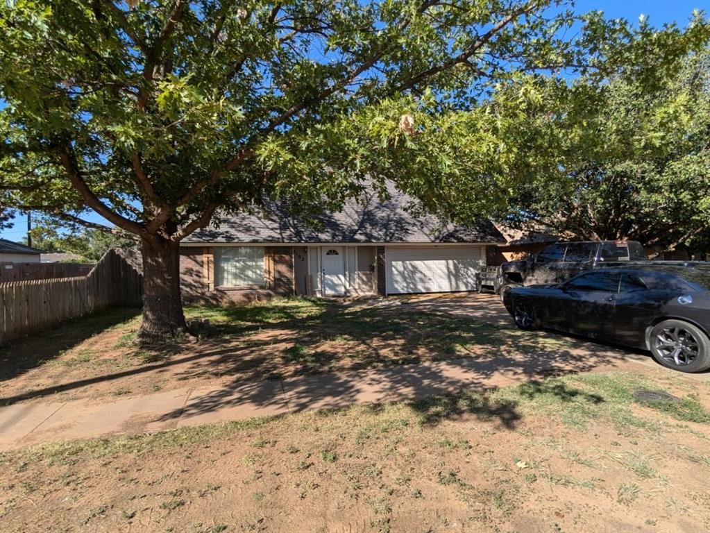 a view of a house with large tree