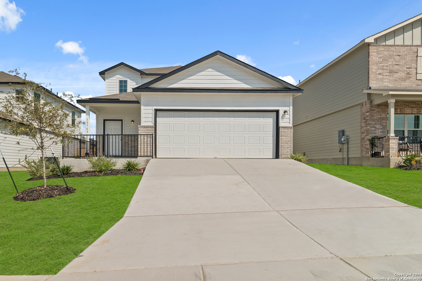 a front view of a house with a yard and garage