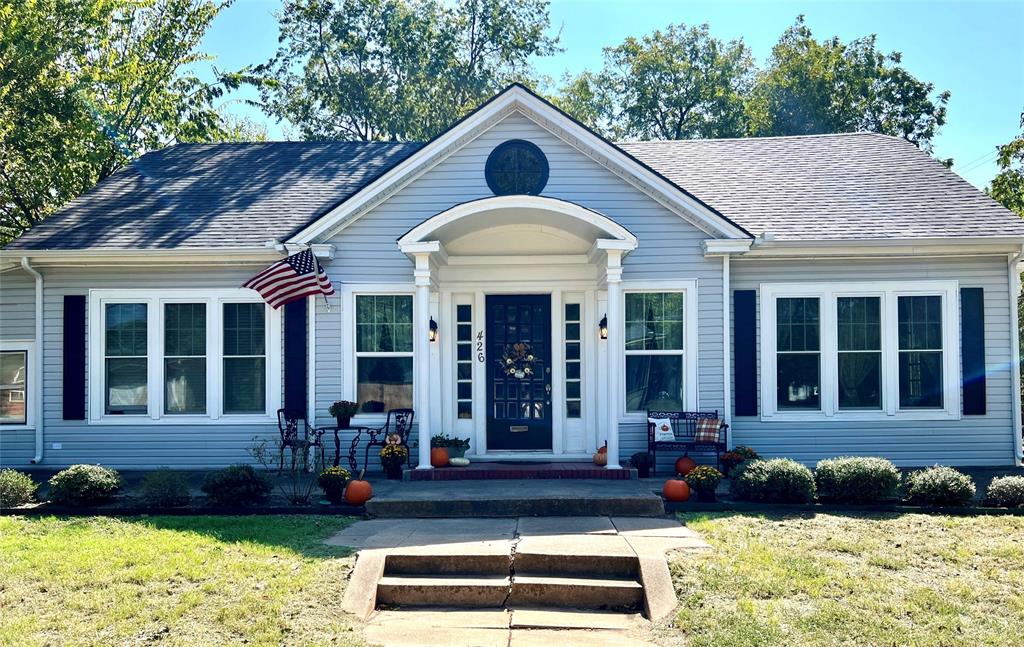 a front view of a house with garden