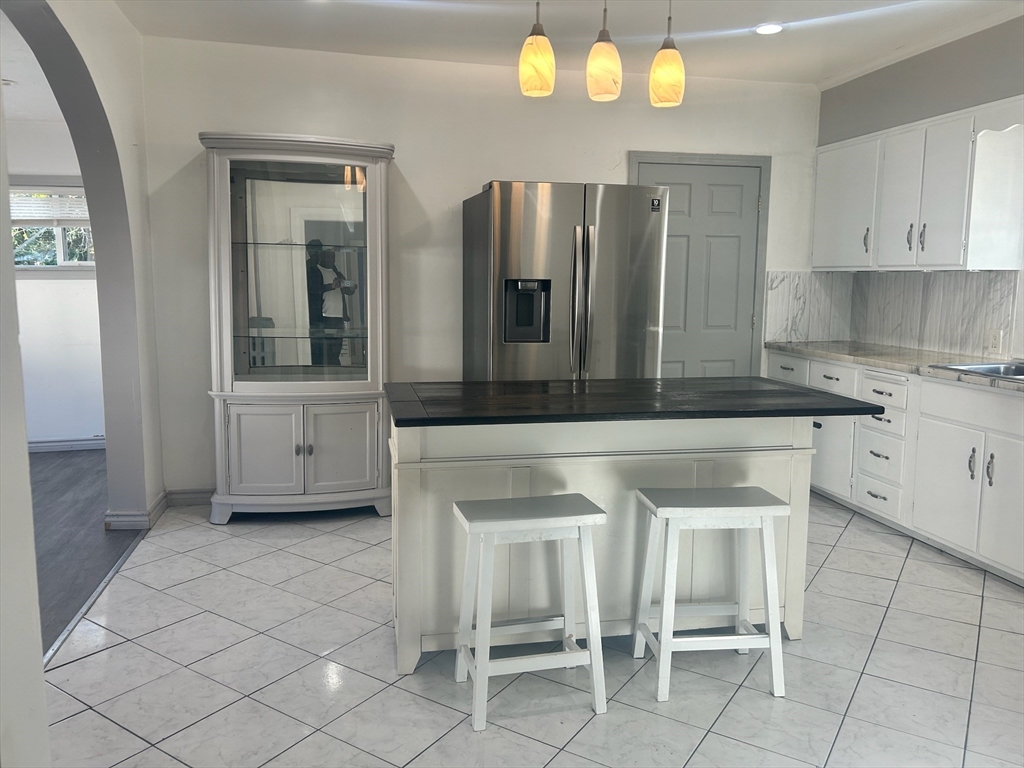 a kitchen with a cabinets and chairs