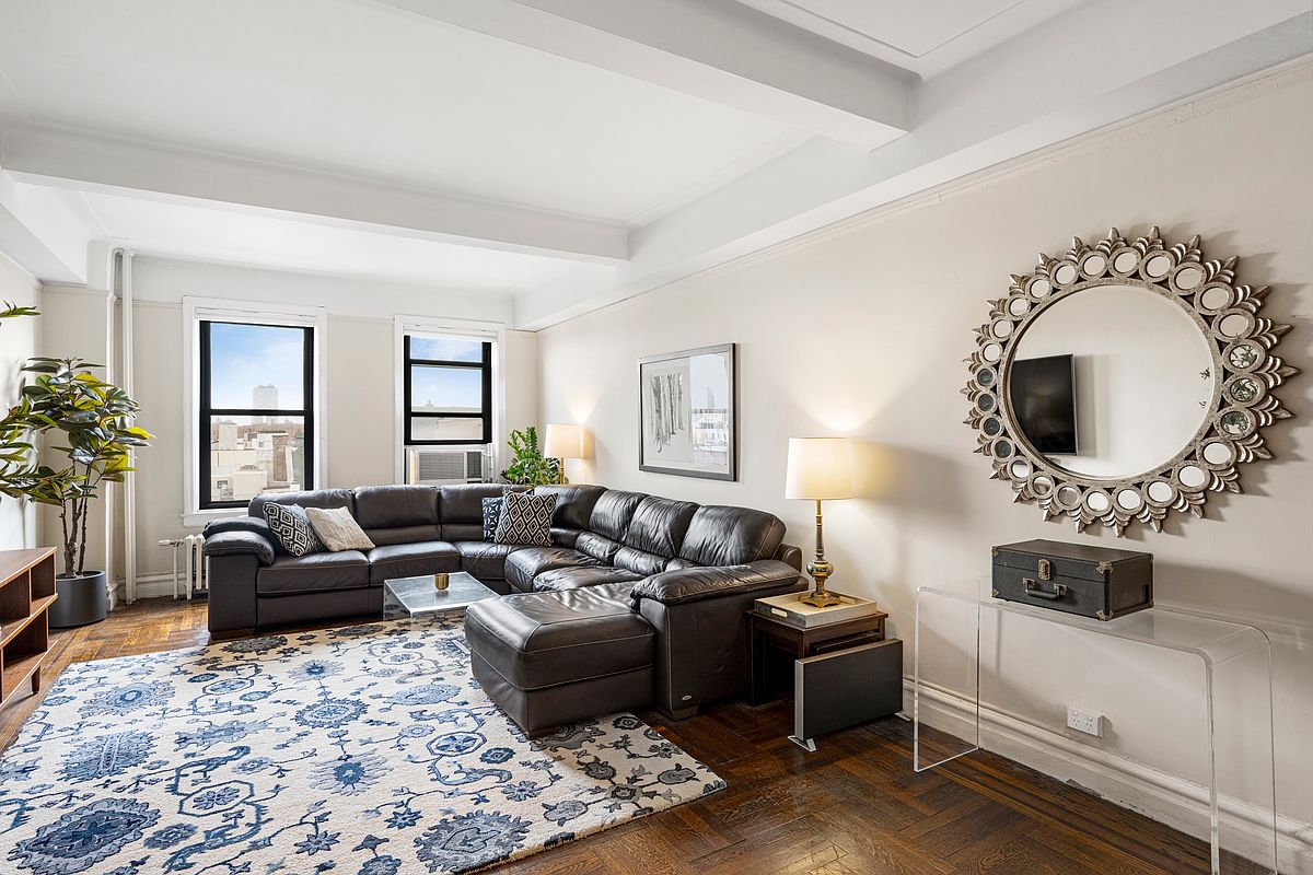 a living room with furniture and a mirror