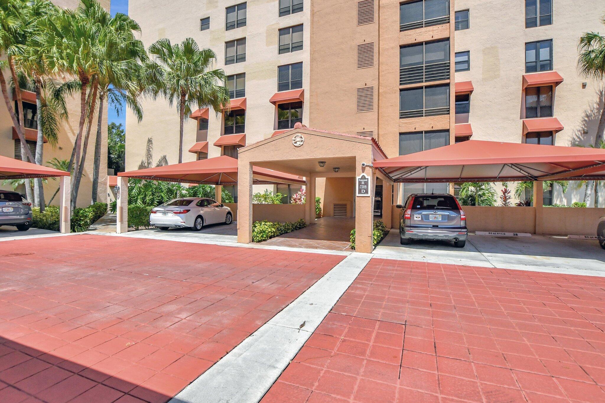 a view of a building with a patio and a yard