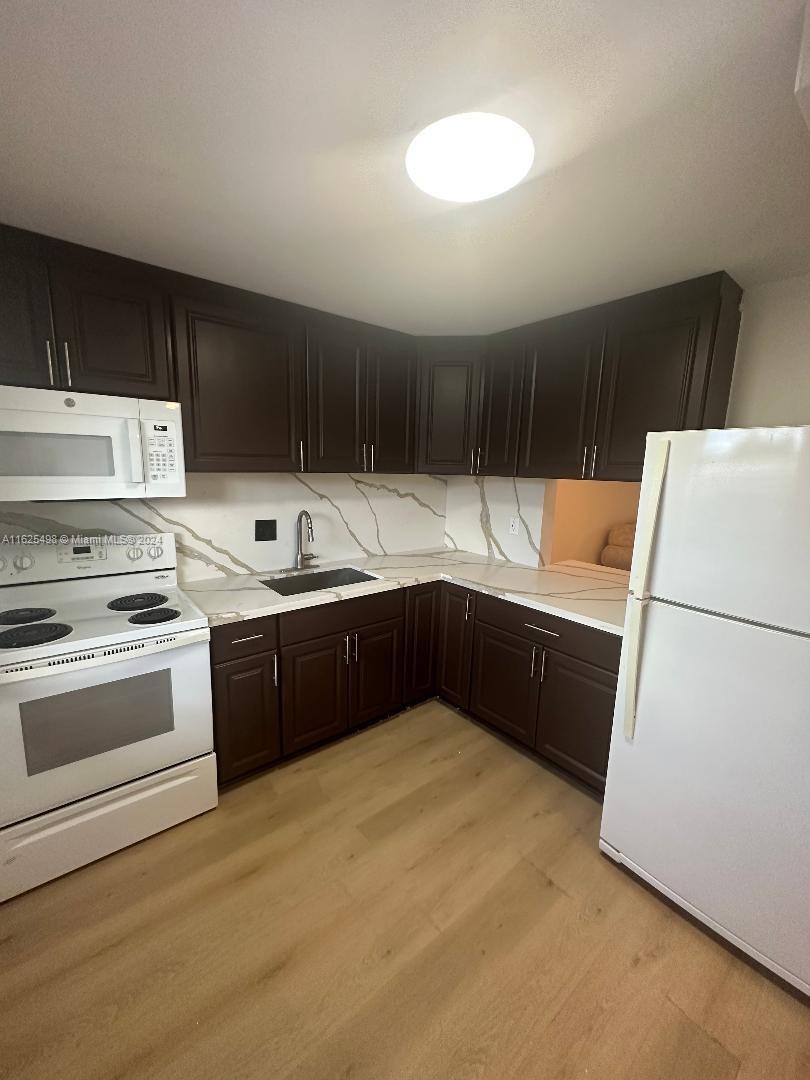 a kitchen with a refrigerator and a sink