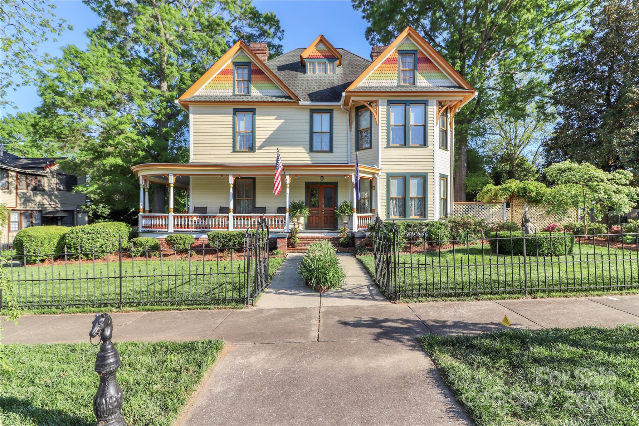 a front view of a house with a garden and plants