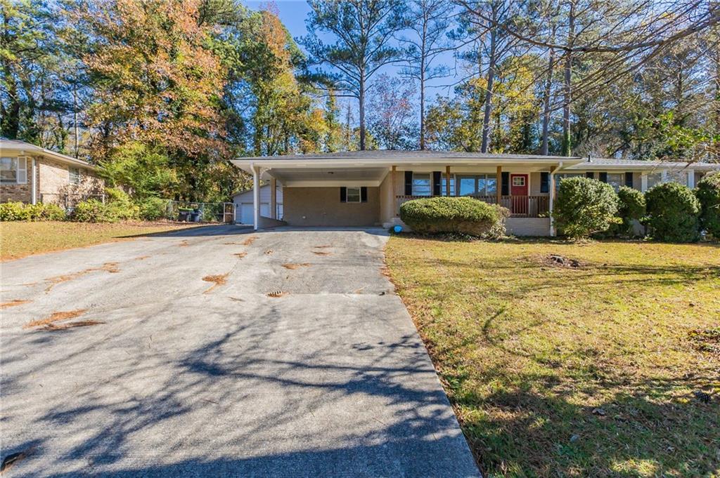 a front view of house with yard and trees around