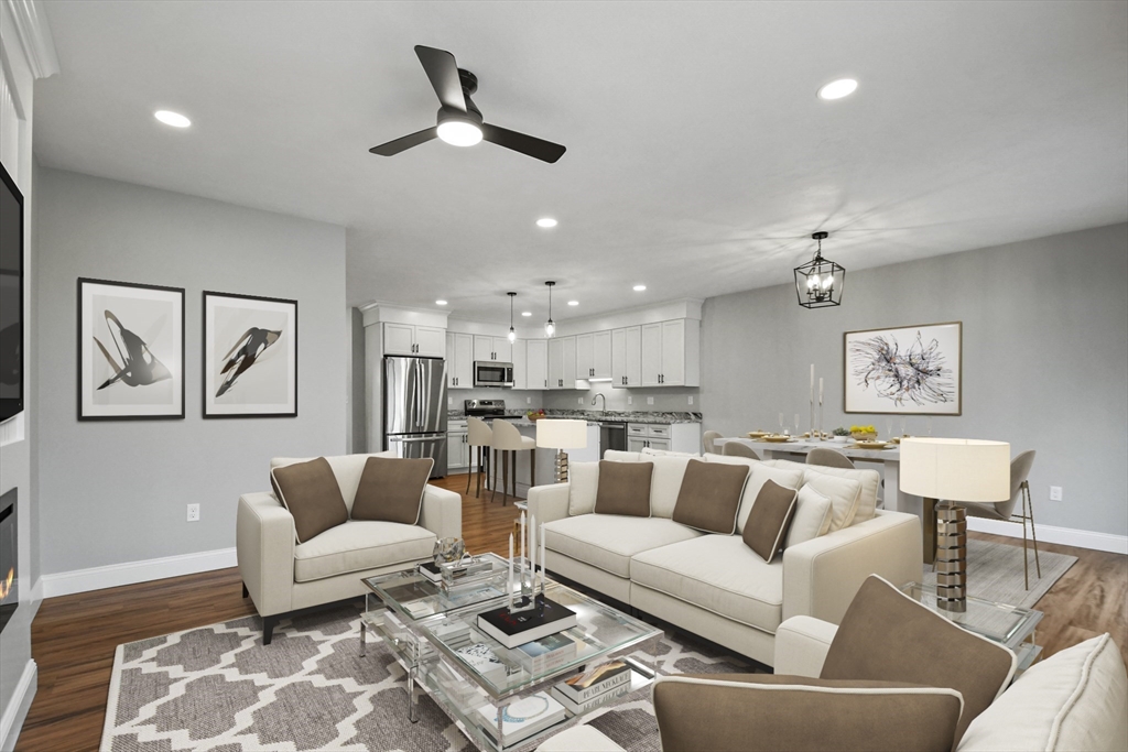 a living room with furniture and kitchen view