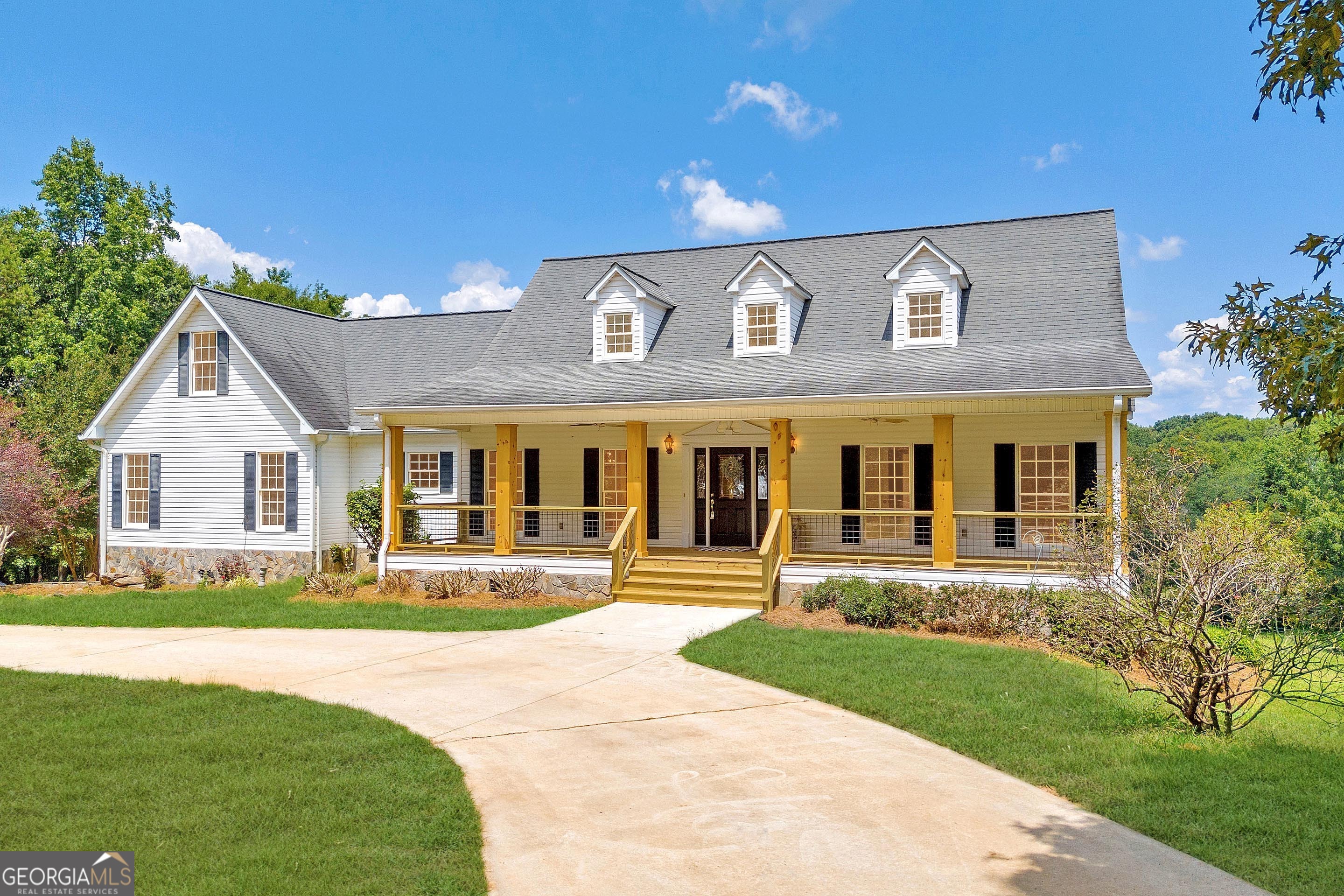 a front view of house with yard and green space