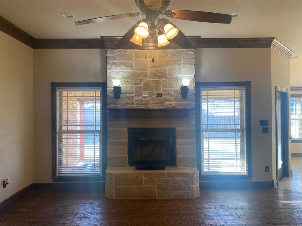 a living room with wooden floor and a fireplace