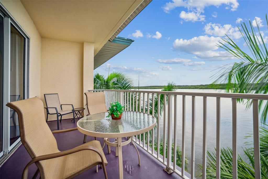 a view of a balcony with table and chairs