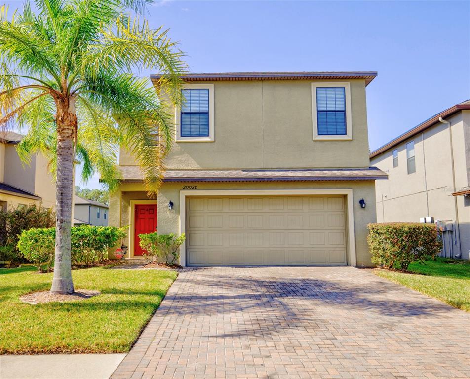 a front view of a house with a yard and garage