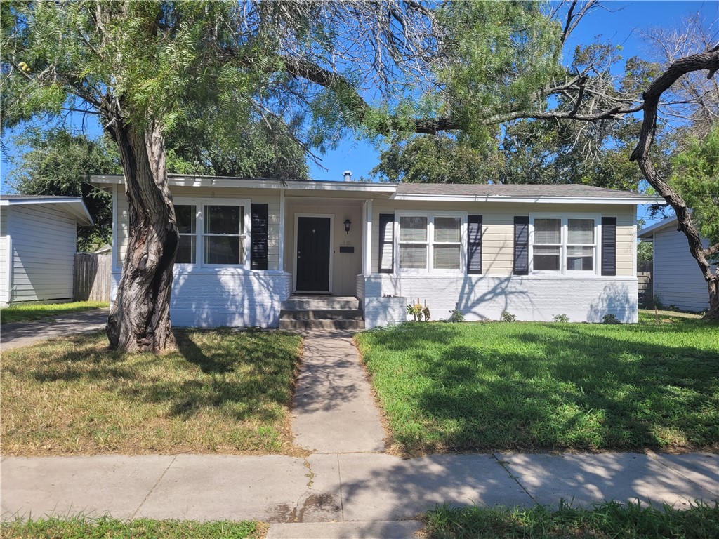 front view of a house with a yard