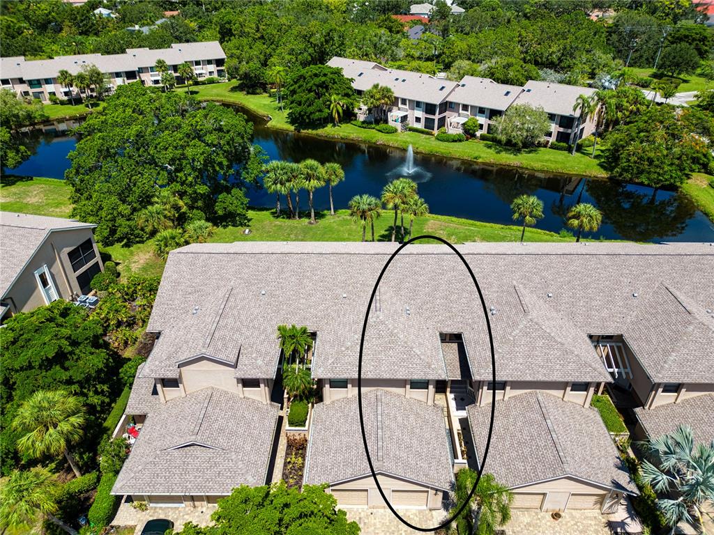 an aerial view of a house with a swimming pool and outdoor seating