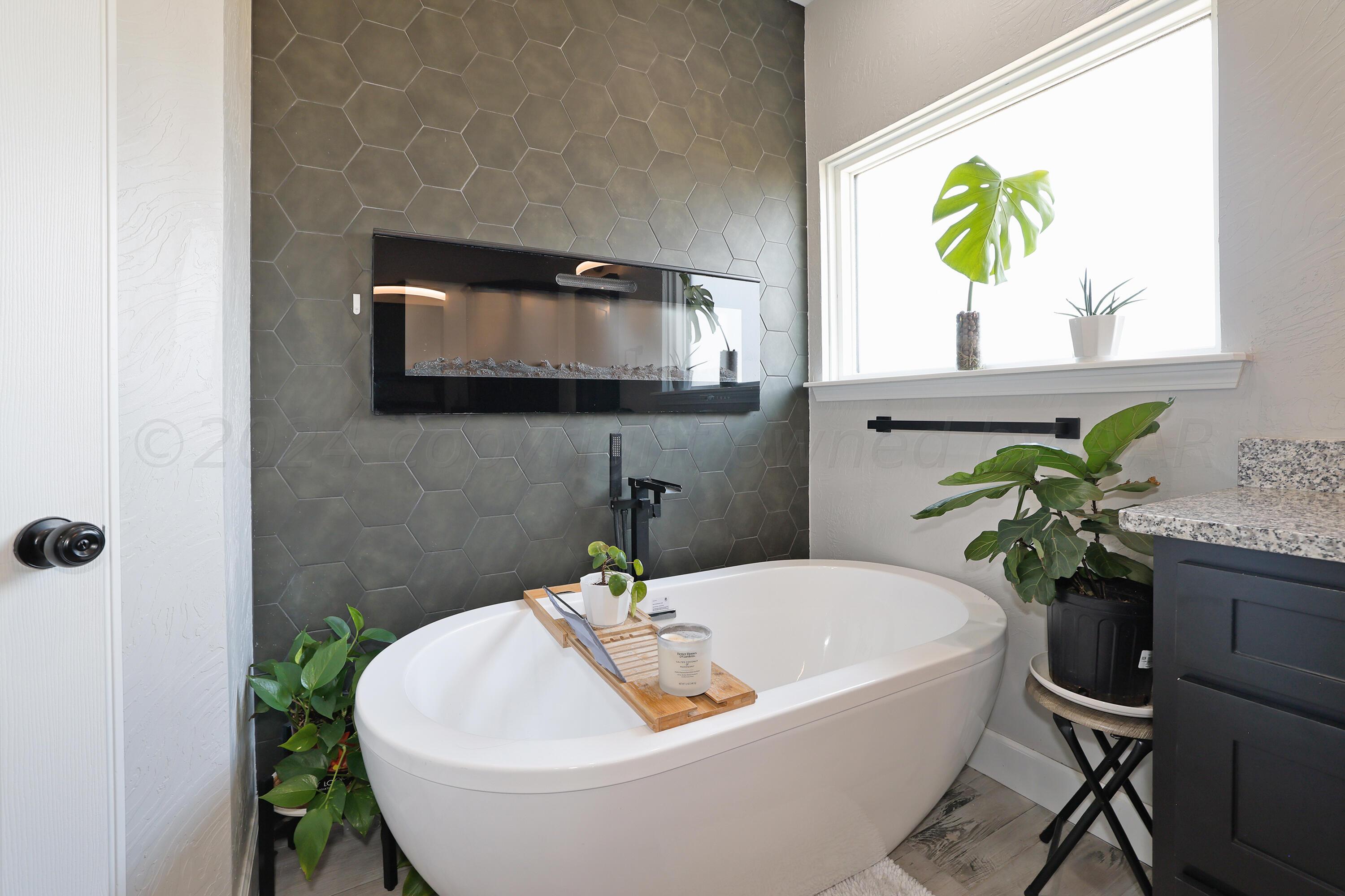 a bath tub sitting in a bathroom next to a window